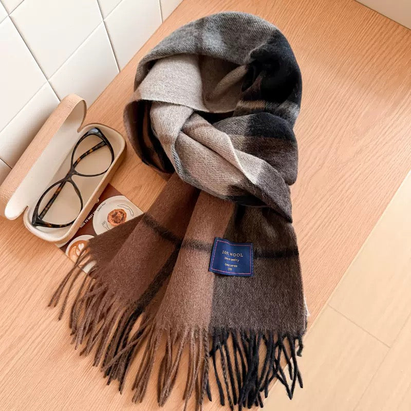 Soft 100% wool plaid scarf in brown, black, and beige, with fringe, next to glasses.