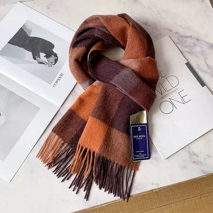Edith 100% wool winter plaid scarf in warm orange, brown, and grey tones with fringe.