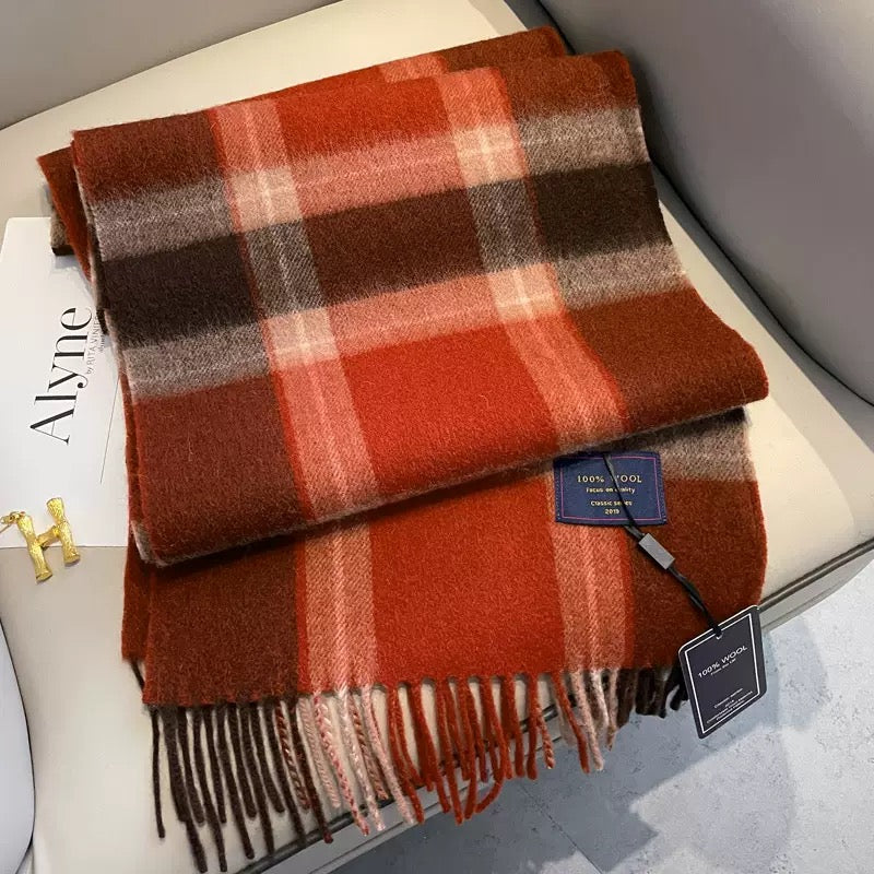 Edith 100% wool winter plaid scarf in warm red, brown, and orange tones with fringe.