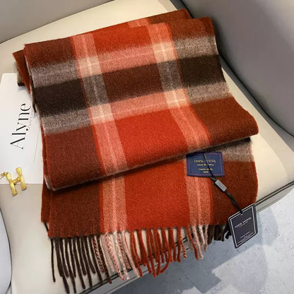 Edith 100% wool winter plaid scarf in warm red, brown, and orange tones with fringe.