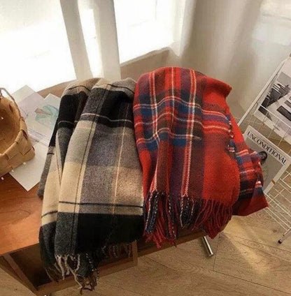 Two 100% wool plaid scarves: one red, blue, and white; the other black, white, and beige. Both have fringe.